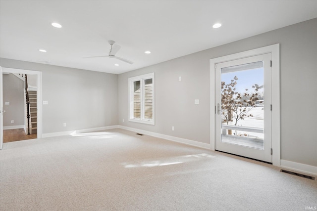 spare room featuring ceiling fan and light colored carpet