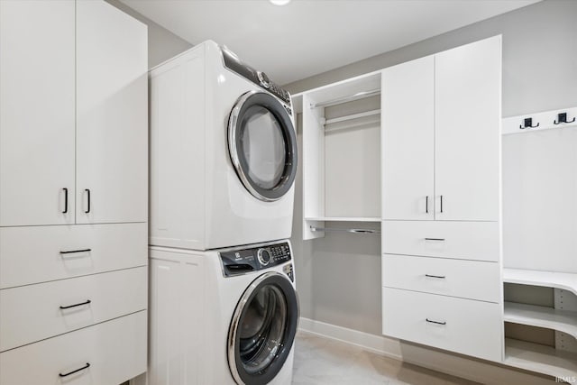 clothes washing area with stacked washer and clothes dryer