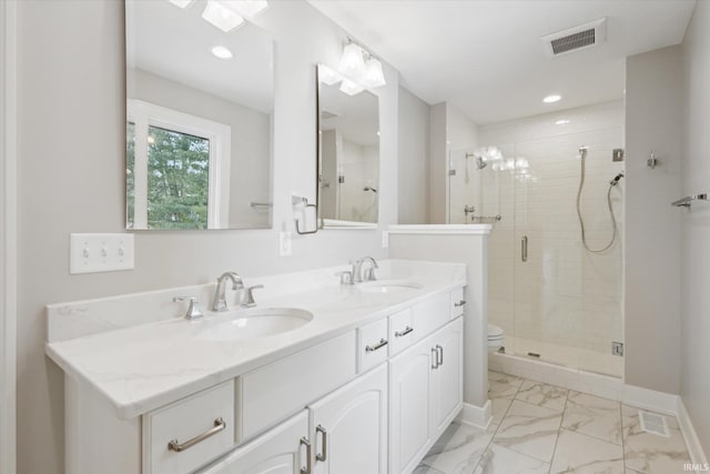 bathroom with an enclosed shower, vanity, and toilet