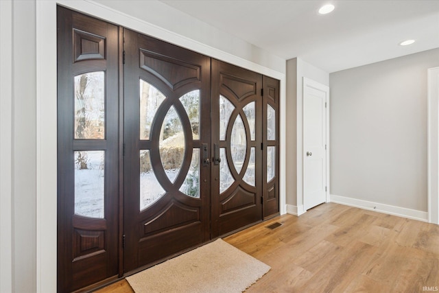 entryway featuring light hardwood / wood-style floors and french doors