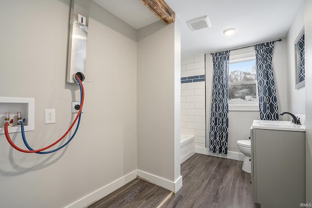 full bathroom featuring wood-type flooring, toilet, shower / bathtub combination with curtain, and vanity