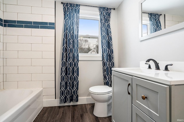 full bathroom featuring hardwood / wood-style flooring, toilet, shower / tub combo, and vanity