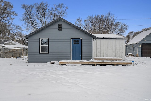 view of snow covered rear of property