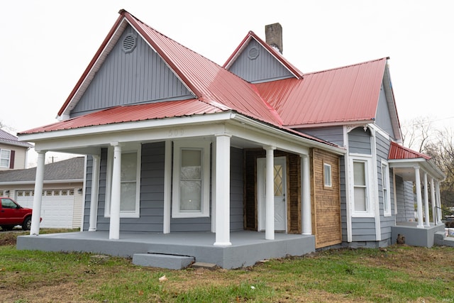 view of front of property featuring covered porch and a garage