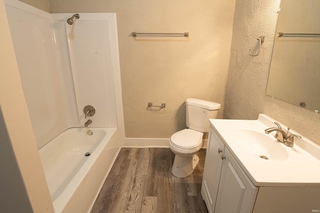 full bathroom featuring vanity, toilet, hardwood / wood-style floors, and shower / bathing tub combination