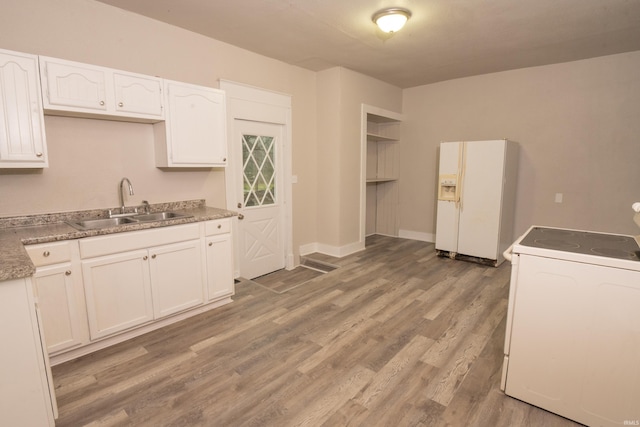 kitchen featuring sink, white cabinetry, white appliances, and wood-type flooring