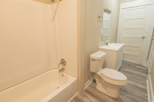 full bathroom with shower / bath combination, hardwood / wood-style floors, toilet, and vanity