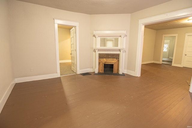 unfurnished living room featuring dark wood-type flooring