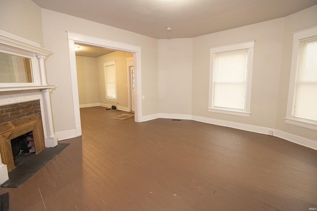 unfurnished living room featuring dark hardwood / wood-style flooring