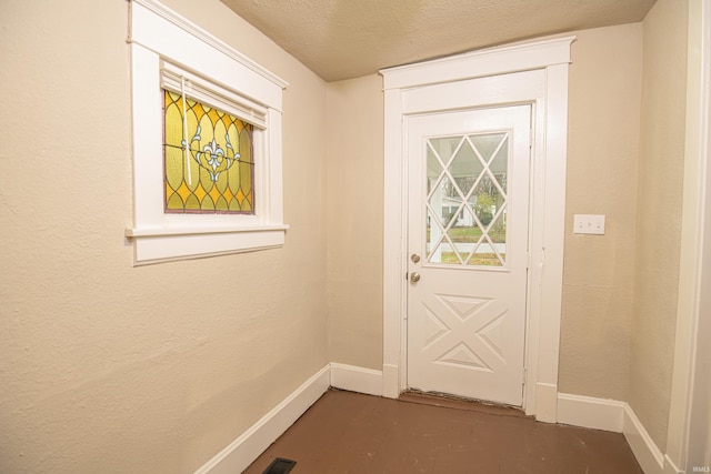 entryway with a textured ceiling