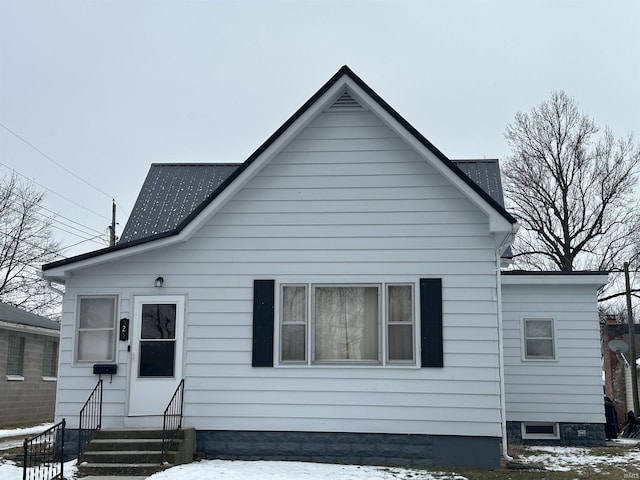 view of snow covered back of property