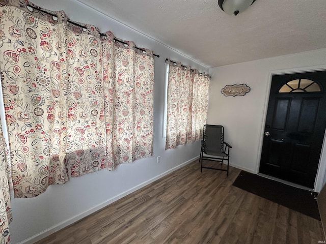 entryway with hardwood / wood-style flooring and a textured ceiling