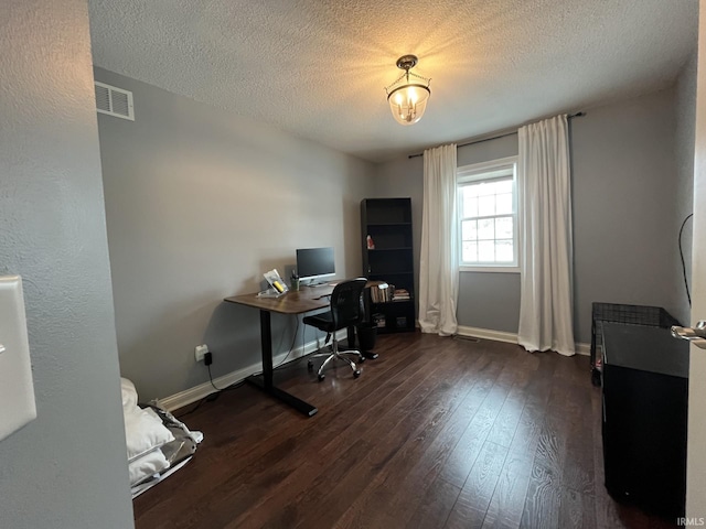 home office featuring a textured ceiling and dark hardwood / wood-style flooring