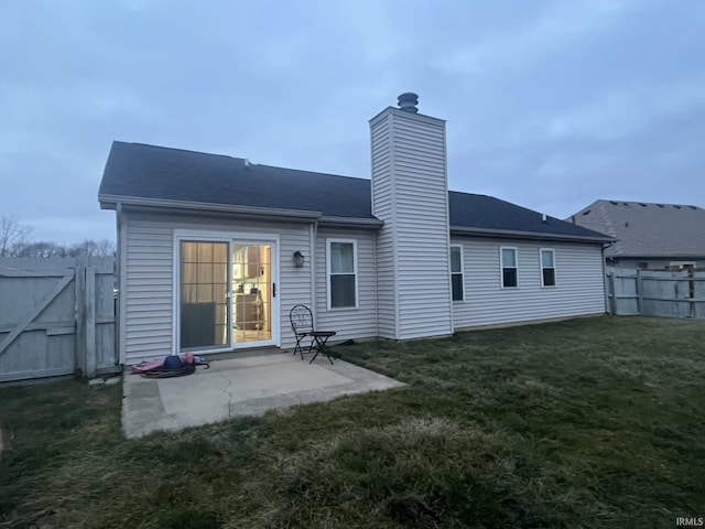 rear view of property with a patio and a yard