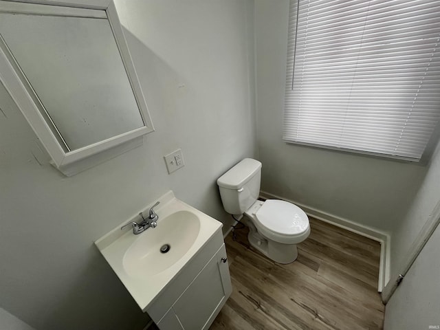 bathroom with vanity, hardwood / wood-style flooring, and toilet