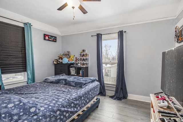 bedroom featuring wood-type flooring, ceiling fan, and ornamental molding