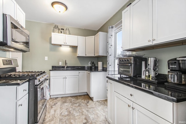 kitchen featuring sink, white cabinetry, and stainless steel appliances