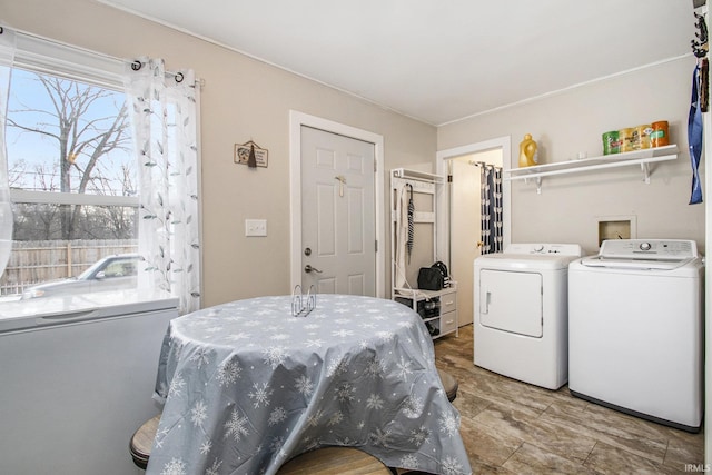 washroom with washing machine and clothes dryer