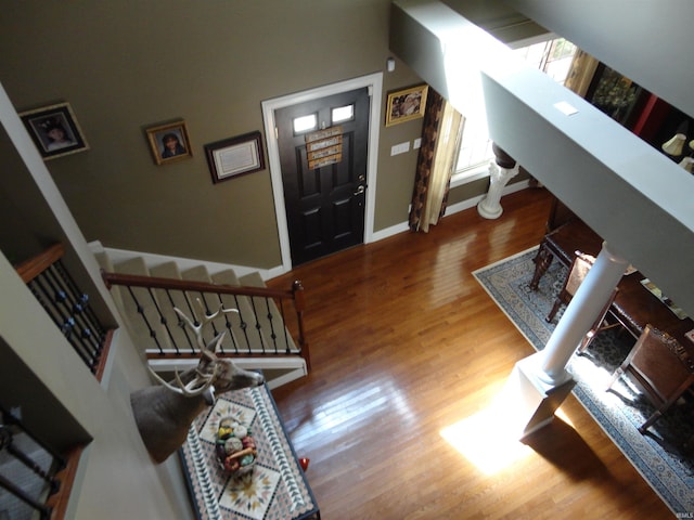 living room with wood-type flooring and ornate columns