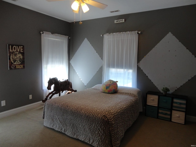 bedroom featuring ceiling fan, carpet floors, and multiple windows