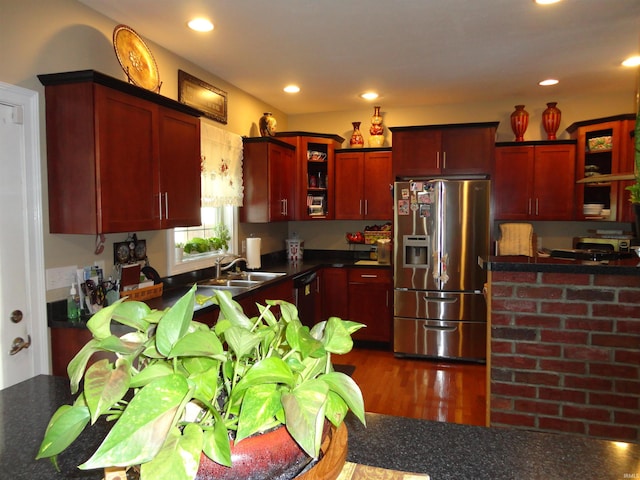 kitchen with sink, dark wood-type flooring, stainless steel fridge, and black dishwasher