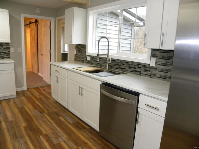 kitchen with sink, white cabinetry, dark hardwood / wood-style floors, and stainless steel appliances