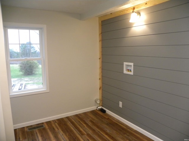 clothes washing area featuring hookup for a washing machine, dark wood-type flooring, and wooden walls