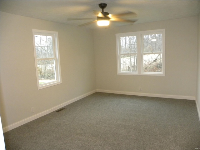 carpeted spare room with ceiling fan