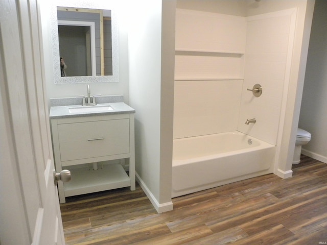 full bathroom with wood-type flooring, toilet, vanity, and bathing tub / shower combination