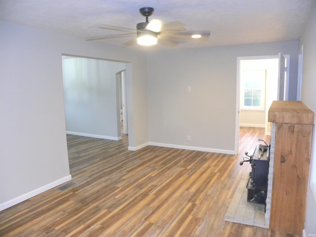 unfurnished room featuring dark hardwood / wood-style floors and ceiling fan