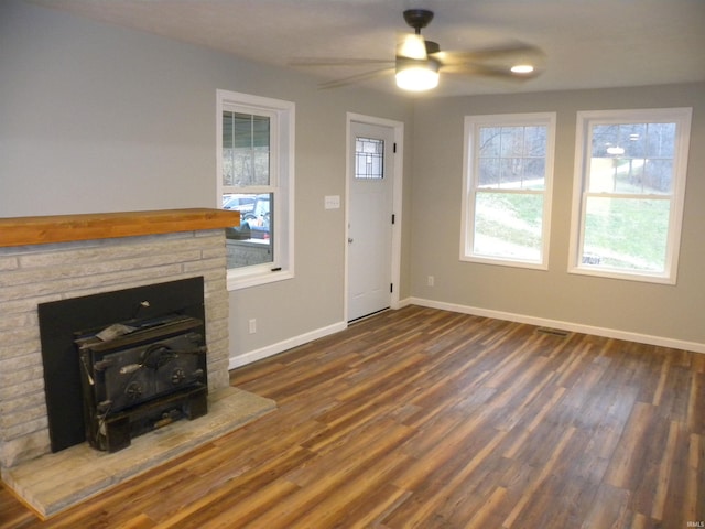 unfurnished living room with dark hardwood / wood-style floors and ceiling fan