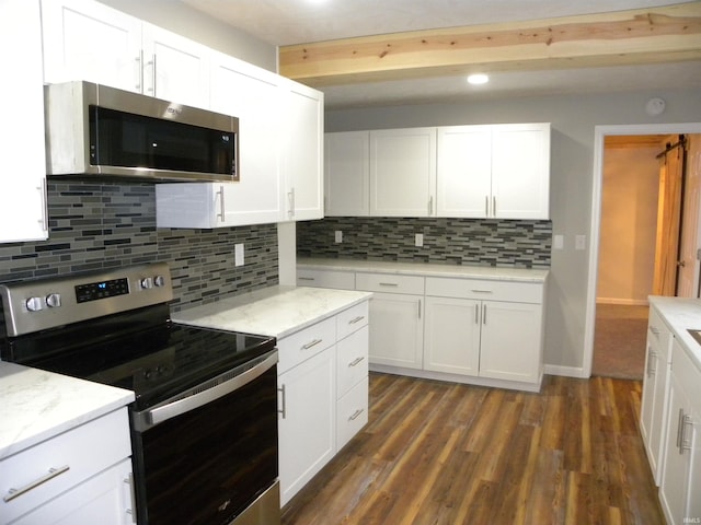 kitchen with decorative backsplash, white cabinetry, appliances with stainless steel finishes, and dark hardwood / wood-style flooring