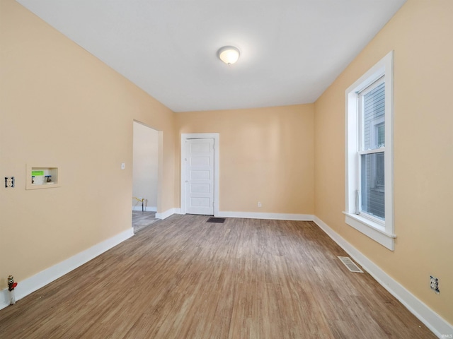 unfurnished room with wood-type flooring