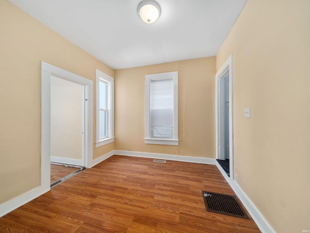 empty room with hardwood / wood-style floors