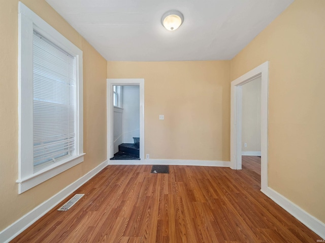 unfurnished room with hardwood / wood-style flooring