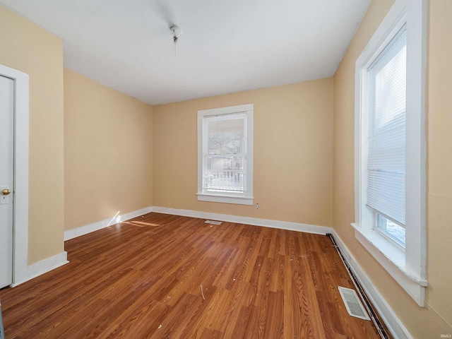 spare room with hardwood / wood-style flooring