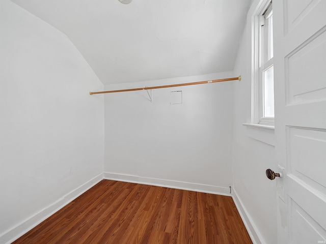 spacious closet featuring hardwood / wood-style flooring and vaulted ceiling