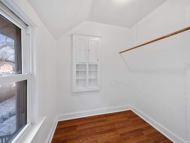 spacious closet featuring hardwood / wood-style flooring and vaulted ceiling