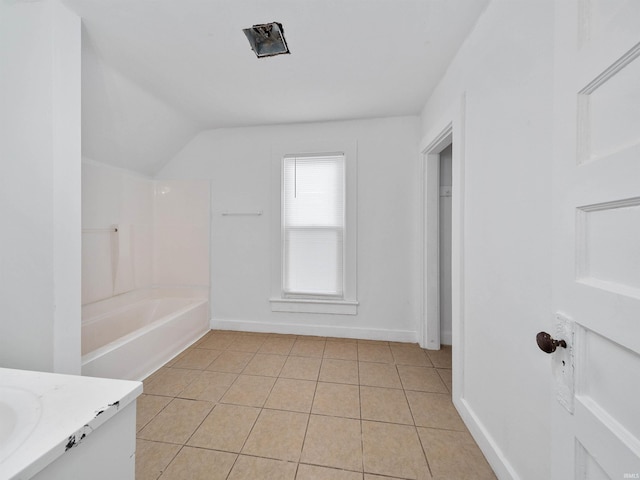 bathroom featuring vaulted ceiling, tile patterned floors, and vanity