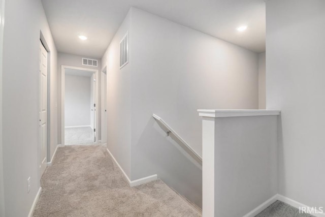 corridor with light colored carpet