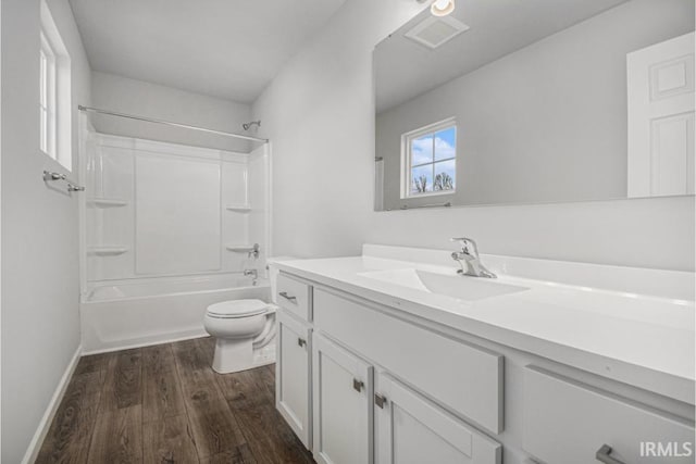 full bathroom with vanity, hardwood / wood-style flooring, shower / tub combination, and toilet