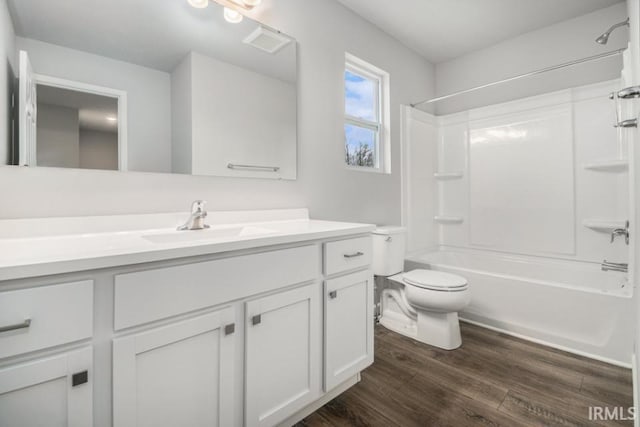 full bathroom with shower / bath combination, hardwood / wood-style floors, toilet, and vanity