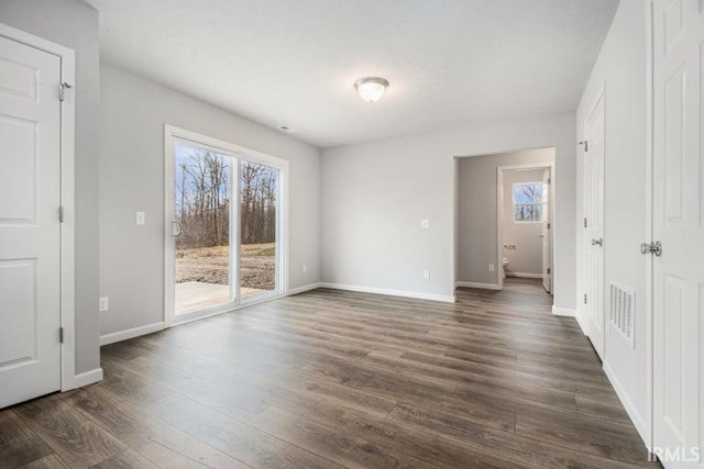 unfurnished room featuring dark hardwood / wood-style floors