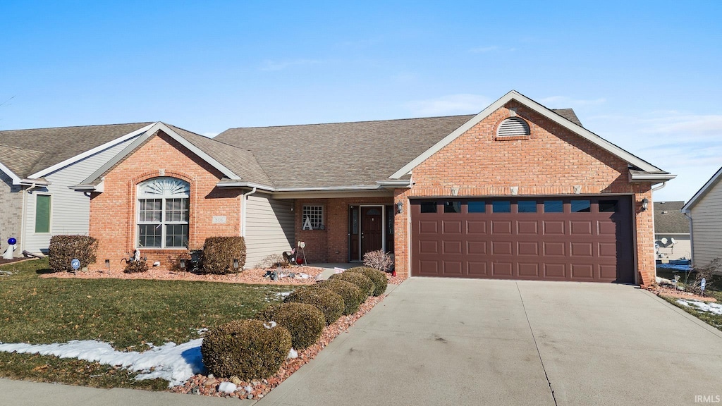 single story home with a garage and a front lawn