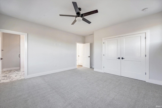 unfurnished bedroom with a closet, ceiling fan, and light colored carpet