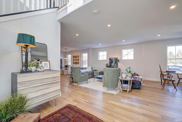 living room featuring a wealth of natural light and light hardwood / wood-style flooring