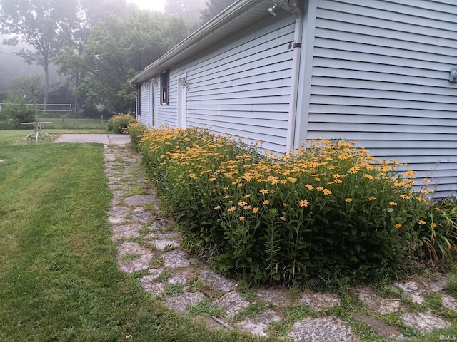 view of side of property with a lawn