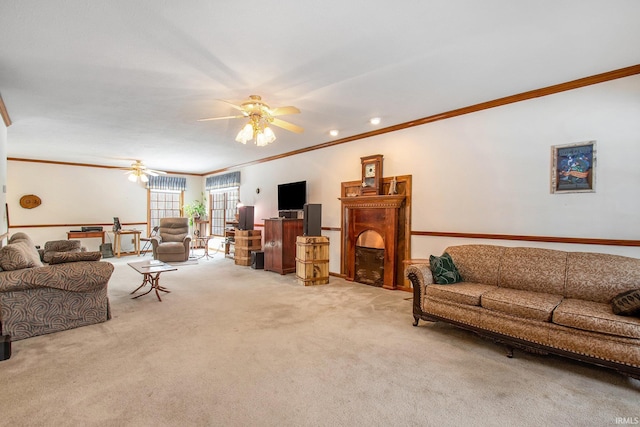 carpeted living room with crown molding and ceiling fan