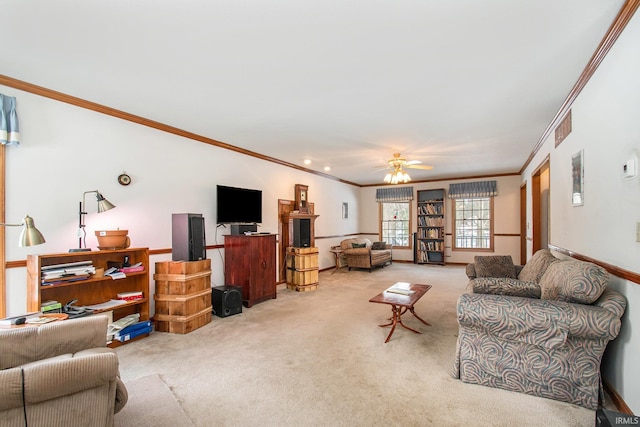 living room with ceiling fan, light colored carpet, and crown molding