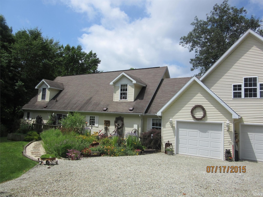 cape cod-style house featuring a garage